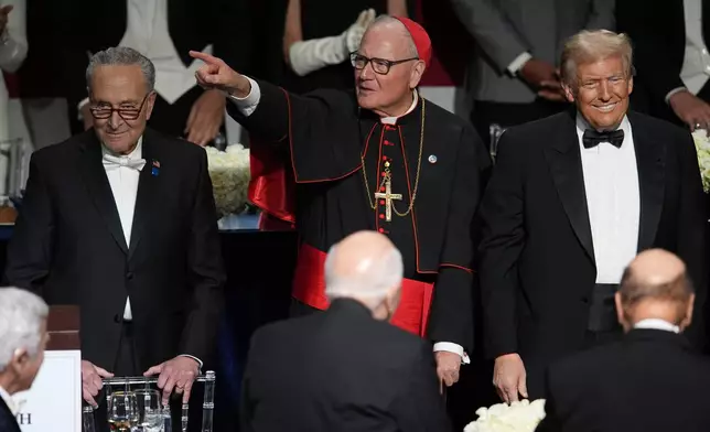 Republican presidential nominee former President Donald Trump, right, Cardinal Timothy Dolan and Senate Majority Leader Chuck Schumer of N.Y., arrive for the 79th annual Alfred E. Smith Memorial Foundation Dinner, Thursday, Oct. 17, 2024, in New York. (AP Photo/Julia Demaree Nikhinson)