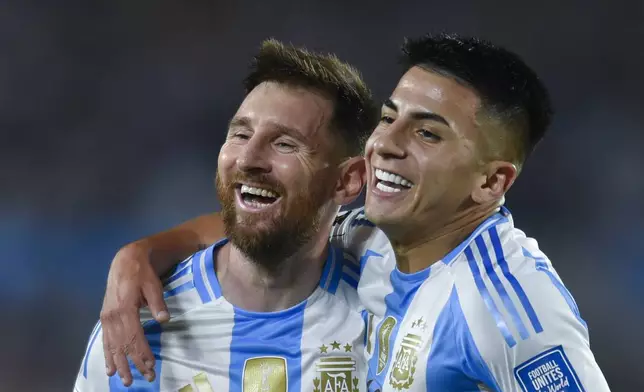 Argentina's Lionel Messi, left, celebrates with teammate Thiago Almada after scoring his side's fifth goal against Bolivia during a World Cup 2026 qualifying soccer match at Monumental stadium in Buenos Aires, Argentina, Tuesday, Oct. 15, 2024. (AP Photo/Gustavo Garello)