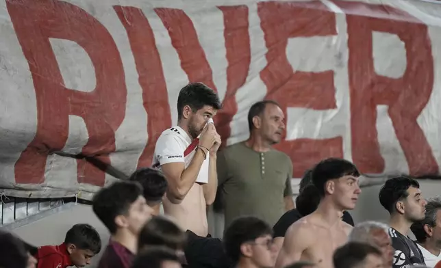 Fans of Argentina's River Plate watch a Copa Libertadores semifinal second leg soccer match against Brazil's Atletico Mineiro at Monumental stadium in Buenos Aires, Argentina, Tuesday, Oct. 29, 2024. (AP Photo/Natacha Pisarenko)