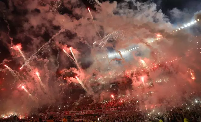 Fans of Argentina's River Plate launch fireworks before the start of a Copa Libertadores semifinal second leg soccer match against Brazil's Atletico Mineiro at Monumental stadium in Buenos Aires, Argentina, Tuesday, Oct. 29, 2024. (AP Photo/Gustavo Garello)