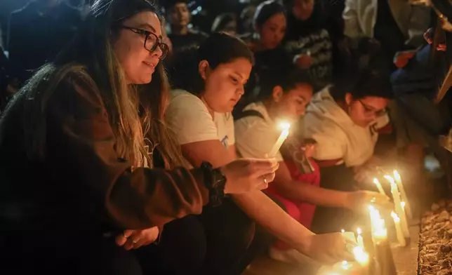 Fans light candles outside the hotel where former One Direction singer Liam Payne was found dead after he fell from a balcony in Buenos Aires, Argentina, Wednesday, Oct. 16, 2024. (AP Photo/Natacha Pisarenko)