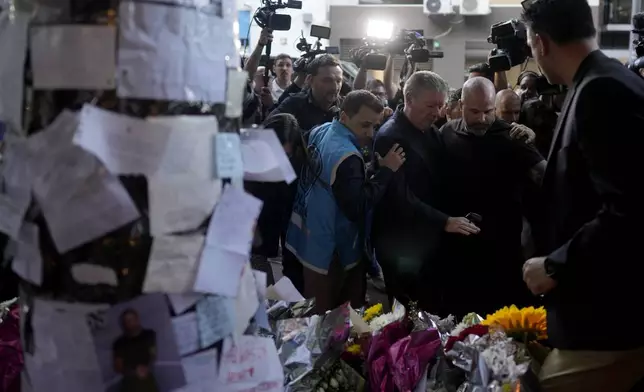 Geoff Payne, center, the father of former One Direction singer Liam Payne, is escorted by police officers as he arrives to the Casa Sur Hotel where his son fell to his death from a hotel balcony, in Buenos Aires, Argentina, Friday, Oct. 18, 2024. (AP Photo/Natacha Pisarenko)