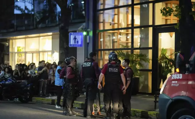 Police gather outside a hotel where Liam Payne, a former member of the band One Direction, was found dead after falling from a balcony in Buenos Aires, Argentina, Wednesday, Oct. 16, 2024. (AP Photo/Natacha Pisarenko)