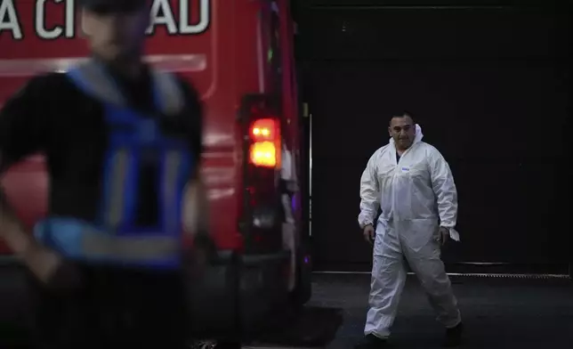 A forensic investigator exits the hotel where English musician Liam Payne, a former member of the band One Direction, was found dead after falling from a balcony in Buenos Aires, Argentina, Wednesday, Oct. 16, 2024. (AP Photo/Natacha Pisarenko)