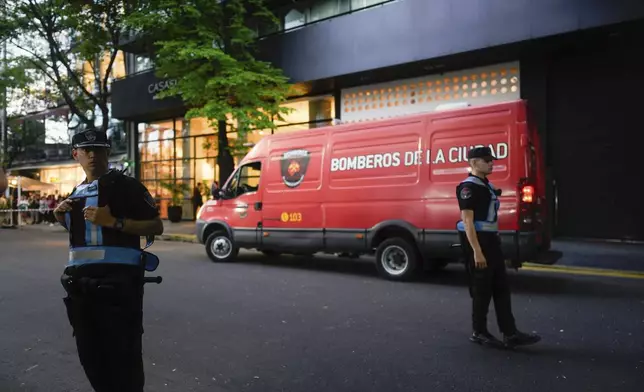 Police stand guard outside a hotel where Liam Payne, a former member of the band One Direction, was found dead after falling from a balcony in Buenos Aires, Argentina, Wednesday, Oct. 16, 2024. (AP Photo/Natacha Pisarenko)