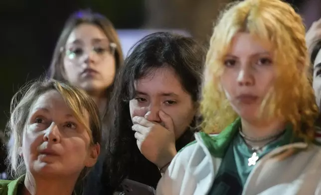 People gather outside the hotel where former One Direction singer Liam Payne was found dead after he fell from a balcony in Buenos Aires, Argentina, Wednesday, Oct. 16, 2024. (AP Photo/Natacha Pisarenko)