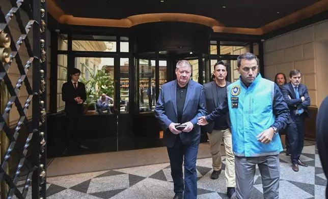 Geoff Payne, the father of the late ex-One Direction singer Liam Payne, center, leaves his hotel in Buenos Aires, Argentina, two days after his son died, Friday, Oct. 18, 2024. (AP Photo/Mario De Fina)