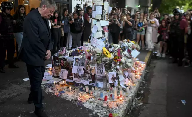 Geoff Payne, left, the father of former One Direction singer Liam Payne, visits a memorial outside the Casa Sur Hotel where the British pop singer fell to his death from a hotel balcony, in Buenos Aires, Argentina, Friday, Oct. 18, 2024. (AP Photo/Mario De Fina)