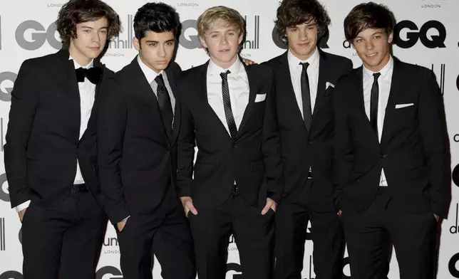 FILE - One Direction's Liam Payne, second from right, poses for a photo with fellow band members Harry Styles, Zayn Malik, Niall Horan and Liam Tomlinson at the GQ Men of the Year Awards in London, Sept. 6, 2011. (AP Photo/Jonathan Short, File)