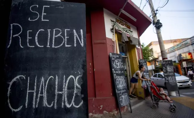 A sign reads in Spanish, "We take chachos" at a butcher shop in La Rioja, Argentina, Monday, Sept. 23, 2024. In response to slashed federal budgets to provinces, La Rioja is printing a new emergency tender called "chachos" to pay state workers and spur the economy. (AP Photo/Natalia Diaz)