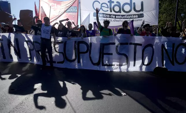 Students block a highway to protest President Javier Milei's veto of a law to increase funding for public universities in Buenos Aires, Argentina, Wednesday, Oct. 16, 2024. (AP Photo/Natacha Pisarenko)