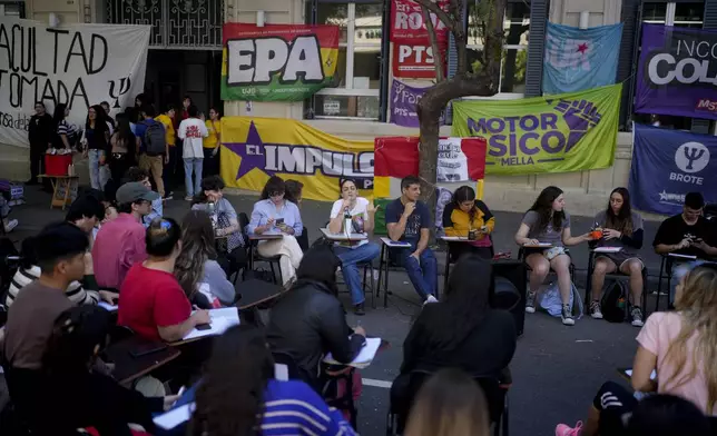 Students hold class in the middle of a street outside the Faculty of Psychology to protest President Javier Milei's veto of higher funding for public universities, in Buenos Aires, Argentina, Wednesday, Oct. 16, 2024. (AP Photo/Natacha Pisarenko)