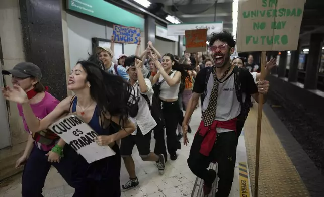 Students exit the subway on their way to a rally outside Congress to protest President Javier Milei's veto of a law to increase funding for public universities in Buenos Aires, Argentina, Wednesday, Oct. 9, 2024. (AP Photo/Rodrigo Abd)