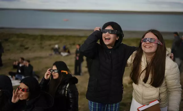 People watch an annular solar eclipse in Puerto San Julian, Argentina, Wednesday, Oct. 2, 2024. (AP Photo/Natacha Pisarenko)