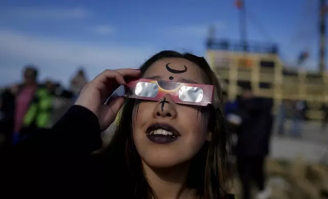 People watch an annular solar eclipse in Puerto San Julian, Argentina, Wednesday, Oct. 2, 2024. (AP Photo/Natacha Pisarenko)