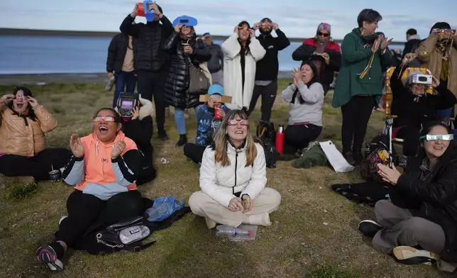 People watch an annular solar eclipse in Puerto San Julian, Argentina, Wednesday, Oct. 2, 2024. (AP Photo/Natacha Pisarenko)