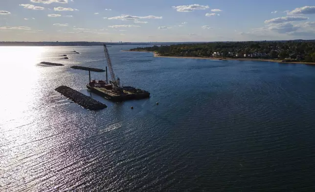 Construction is wrapping up on eight, eco-friendly "Living Breakwaters" at the southernmost tip of New York City, off the coast of Staten Island, Wednesday, Oct. 9, 2024, where artificial reefs were constructed as part of a strategy to reduce risk from hurricanes after Superstorm Sandy pummeled the region in 2012. (AP Photo/Ted Shaffrey)