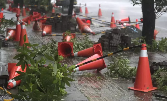 Traffic cones litter the pavement as Typhoon Krathon arrives in Kaohsiung, southern Taiwan, Thursday, Oct. 3, 2024. (AP Photo/Chiang Ying-ying)