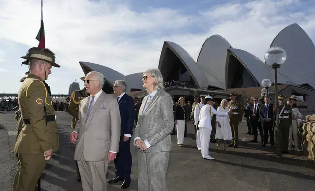 Britain's King Charles III, second from left, talks to an honor guard beside Australia's Governor-General Sam Mostyn during his visit to Sydney Opera House in Sydney, Australia, Tuesday, Oct. 22, 2024. (AP Photo/Mark Baker, Pool)