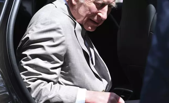 King Charles III exits a car as he arrives with Queen Camilla for a visit to St Thomas' Anglican Church in Sydney, Sunday, Oct. 20, 2024. (Dean Lewins/Pool Photo via AP)