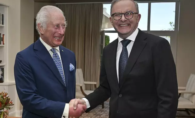 Britain's King Charles III shakes hands with Australia's Prime Minister Anthony Albanese, right, at Government House in Canberra, Australia, Monday, Oct. 21, 2024. (Saeed Khan/Pool Photo via AP)