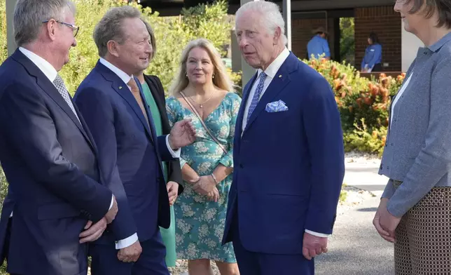 Britain's King Charles III, 2nd from right, talk with Australian Andrew Forrest, 2nd from left, before entering Australian National Botanic Gardens in Canberra, Monday, Oct. 21, 2024. (AP Photo/Mark Baker, Pool)