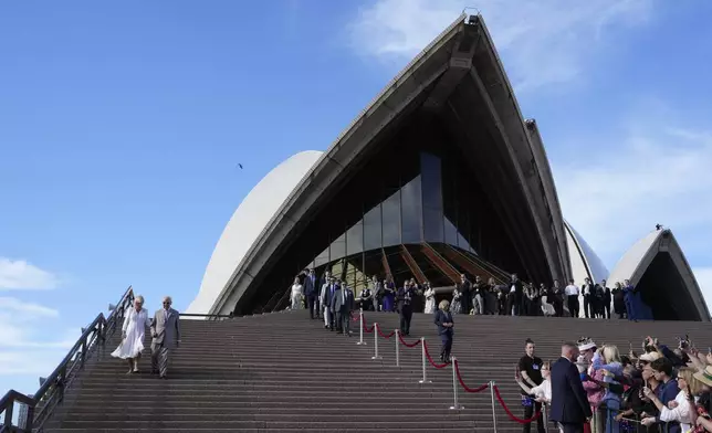 Britain's King Charles III and Queen Camilla goes down the stairs of the Sydney Opera House during their visit in Sydney, Australia, Tuesday, Oct. 22, 2024. (AP Photo/Mark Baker, Pool)