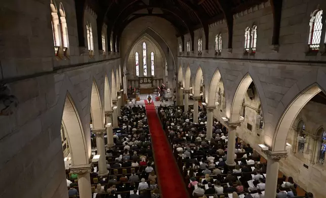 Attendees, including King Charles III and Queen Camilla, sit during a visit to St Thomas' Anglican Church in Sydney, Sunday, Oct. 20, 2024. (Dean Lewins/Pool Photo via AP)