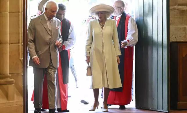 King Charles III, left, and Queen Camilla, center, arrive during a visit to St Thomas' Anglican Church in Sydney, Sunday, Oct. 20, 2024. (Dean Lewins/Pool Photo via AP)