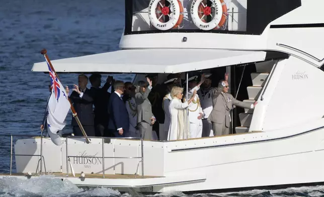 Britain's King Charles III, right, and Queen Camilla rides a yacht along the harbor in Sydney, Australia, Tuesday, Oct. 22, 2024. (AP Photo/Mark Baker, Pool)