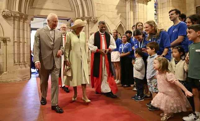 King Charles III, left, and Queen Camilla, center left, arrive for a visit to St Thomas' Anglican Church in Sydney, Sunday, Oct. 20, 2024. (Dean Lewins/Pool Photo via AP)