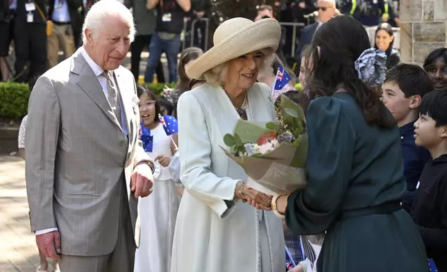 King Charles III, left, and Queen Camilla, center, greet people during a visit to St Thomas' Anglican Church in Sydney, Sunday, Oct. 20, 2024. (Dean Lewins/Pool Photo via AP)