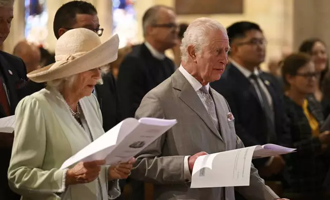 King Charles III, right, and Queen Camilla, left, stand during a visit to St Thomas' Anglican Church in Sydney, Sunday, Oct. 20, 2024. (Dean Lewins/Pool Photo via AP)