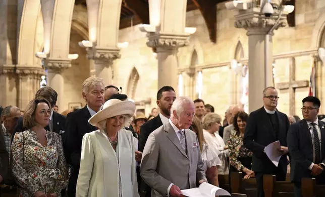 King Charles III, center right, and Queen Camilla, center left, stand during a visit to St Thomas' Anglican Church in Sydney, Sunday, Oct. 20, 2024. (Dean Lewins/Pool Photo via AP)