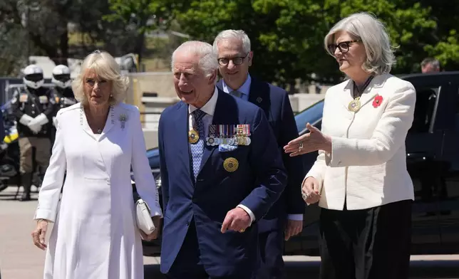 Australia's Governor-General Sam Mostyn, right, escorts Britain's King Charles III, front center, and Queen Camilla as they arrive at the Australian War Memorial in Canberra Monday, Oct. 21, 2024. (AP Photo/Mark Baker, Pool)