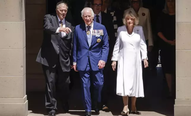 King Charles III and Queen Camilla arrive at the Australian War Memorial accompanied by Australian War Memorial Council Chair Kim Beazley, left, in Canberra, Australia, Monday, Oct. 21, 2024. (Brook Mitchell/ Pool Photo via AP)