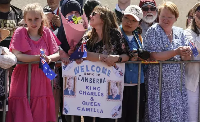 People wait to see Britain's King Charles III and Queen Camilla outside Parliament House in Canberra, Australia, Monday, Oct. 21, 2024. (David Gray/Pool Photo via AP)