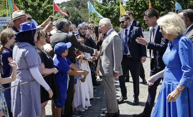 Britain's King Charles III and Queen Camilla meets the crowd as they attend the Premier's Community BBQ on Tuesday Oct. 22, 2024 in Sydney, Australia. (Brook Mitchell/Pool Photo via AP)