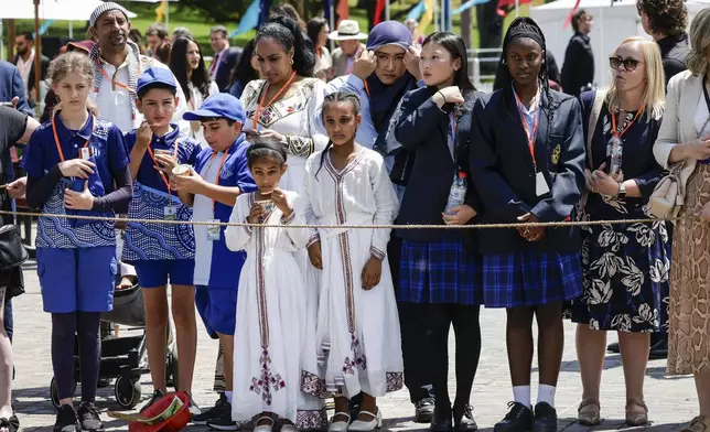 Members of the public wait for Britain's King Charles III and Queen Camilla to arrive to attend the Premier's Community BBQ on Tuesday Oct. 22, 2024 in Sydney, Australia. (Brook Mitchell/Pool Photo via AP)