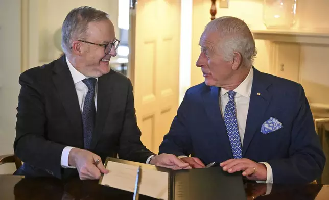 Britain's King Charles III and Australia's Prime Minister Anthony Albanese sign royal warrants granting the Great Seal of Australia at Government House in Canberra, Australia, Monday, Oct. 21, 2024. (Saeed Khan/Pool Photo via AP)