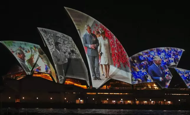 The Sydney Opera House sails show photos of Britain's King Charles and Queen Camilla soon after their arrival in Sydney, Australia, Friday, Oct. 18, 2024. (AP Photo/Mark Baker)