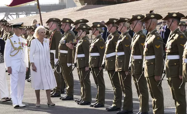 Britain's Queen Camilla inspects honor guards during their visit at the Sydney Opera House in Sydney, Australia, Tuesday, Oct. 22, 2024. (AP Photo/Mark Baker, Pool)