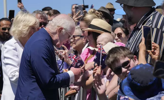 Britain's King Charles III, and Queen Camilla chats with public before they leave the Australian War Memorial in Canberra, Monday, Oct. 21, 2024. (AP Photo/Mark Baker, Pool)