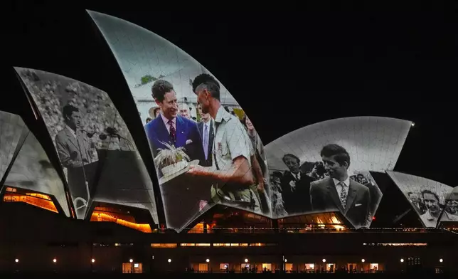 The Sydney Opera House sails show photos of Britain's King Charles soon after his arrival in Sydney, Australia, Friday, Oct. 18, 2024. (AP Photo/Mark Baker)