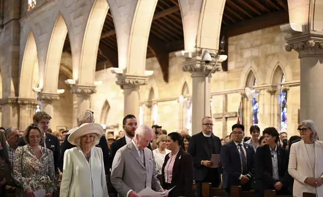 King Charles III, center left, and Queen Camilla, second from front left, stand during a visit to St Thomas' Anglican Church in Sydney, Sunday, Oct. 20, 2024. (Dean Lewins/Pool Photo via AP)