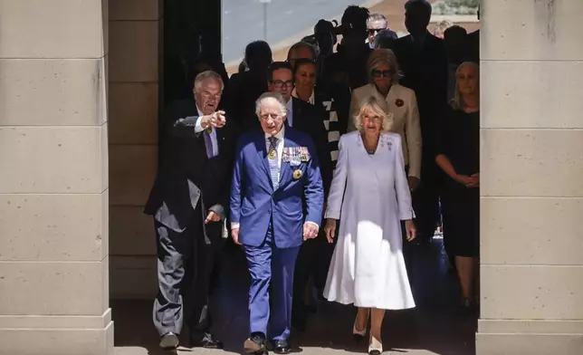 King Charles III and Queen Camilla arrive at the Australian War Memorial accompanied by Australian War Memorial Council Chair Kim Beazley, left, in Canberra, Australia, Monday, Oct. 21, 2024. (Brook Mitchell/Pool Photo via AP)