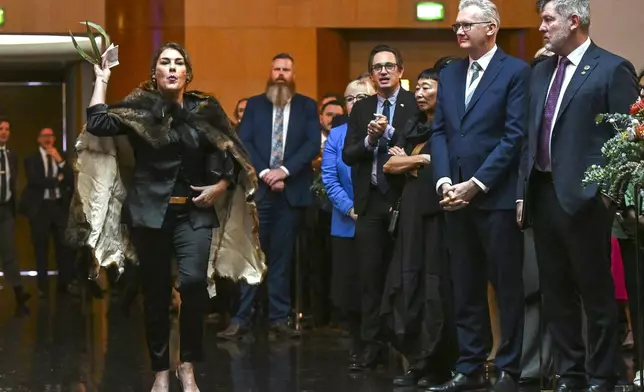 Australian Senator Lidia Thorpe, left, disrupts proceedings as Britain's King Charles and Queen Camilla attend a Parliamentary reception hosted by Australian Prime Minister Anthony Albanese and partner Jodie Jaydon at Parliament House in Canberra, Australia, Monday, Oct. 21, 2024. (Lukas Coch/Pool Photo via AP)