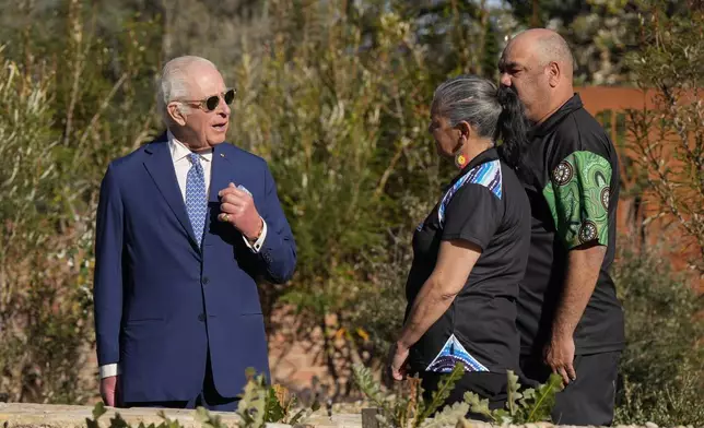 Britain's King Charles III, left, talks with staff during a visit to Australian National Botanic Gardens in Canberra, Monday, Oct. 21, 2024. (AP Photo/Mark Baker, Pool)