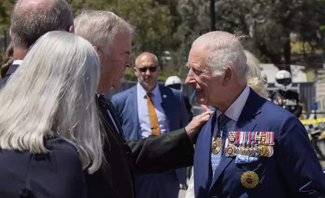 Kim Beazley, third left, chair of Australian War Memorial Council, meets Britain's King Charles III, right, on the king's arrival with Queen Camilla in Canberra, Australia, Monday, Oct. 21, 2024.