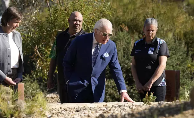 Britain's King Charles III, center, inspect plants during a visit to Australian National Botanic Gardens in Canberra, Monday, Oct. 21, 2024. (AP Photo/Mark Baker, Pool)